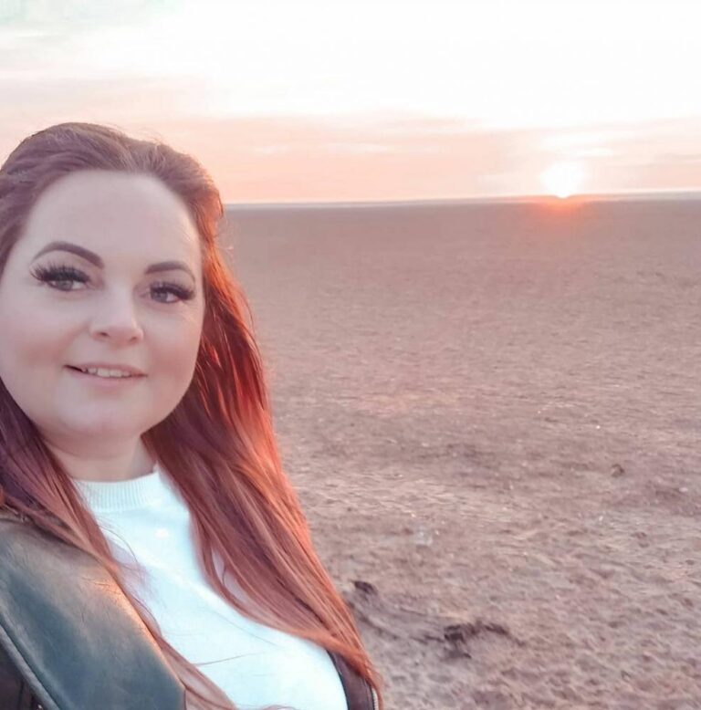 Dawn Baxter on beach at sunrise