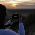 camera woman sunset beach